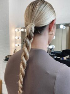 Woman with a braided ponytail hairstyle for work