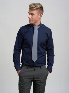 Navy shirt matched with a grey tie for a sleek formal appearance